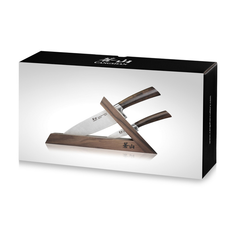 Three knives with wooden handles displayed in a triangular walnut knife block on product packaging.