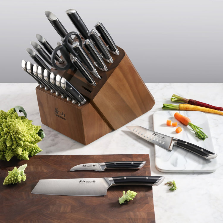 23-piece knife block set with various knives, kitchen shears, and a sharpening rod in a wooden block on a countertop.