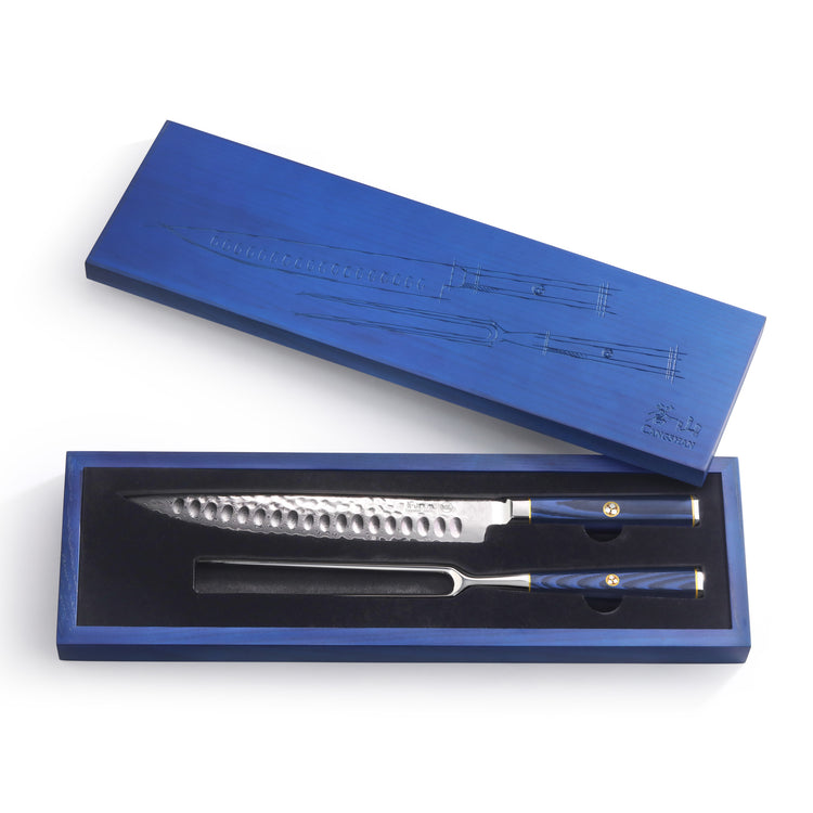 Blue boxed set containing a carving knife and carving fork with hammered blades and blue handles.