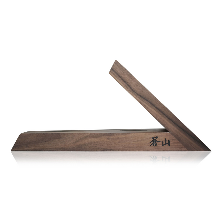 Walnut wood knife block with a triangular design and Japanese characters engraved on one side.