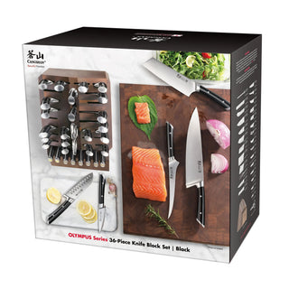 
                    
                      36-piece black knife block set with various knives, a cutting board, salmon fillet, lemon slices, and salad.
                    
                  