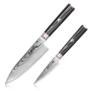 
                    
                      Two Damascus steel kitchen knives with black handles and red accents, one larger chef knife and one smaller paring knife.
                    
                  