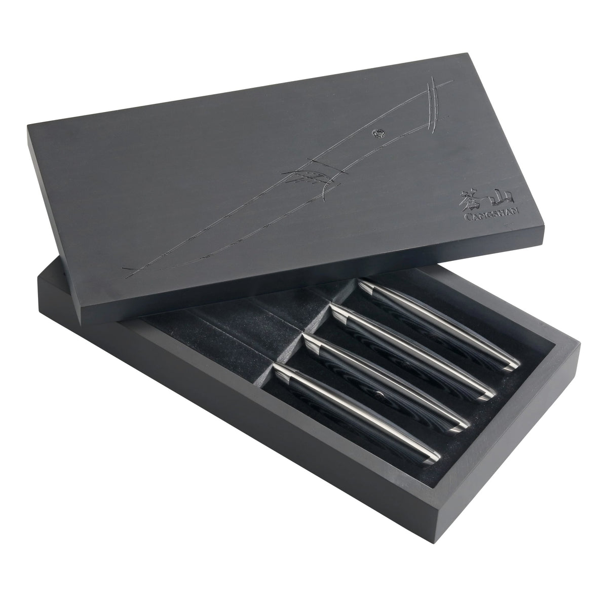 Four steak knives with polished metal handles in a partially open black presentation box with embossed design.