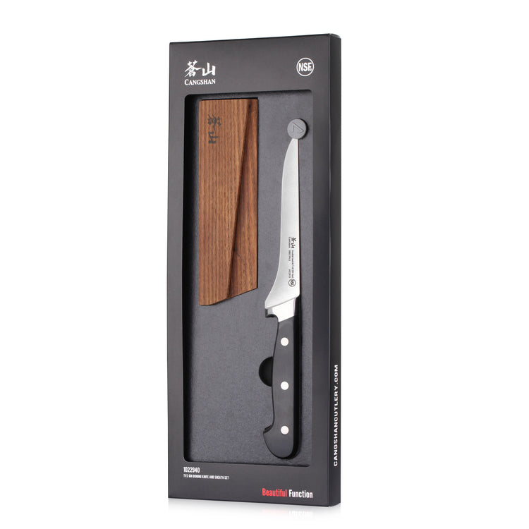Japanese-style kitchen knife with wooden sheath in black packaging labeled "Cangshan" and "NSF" certification.