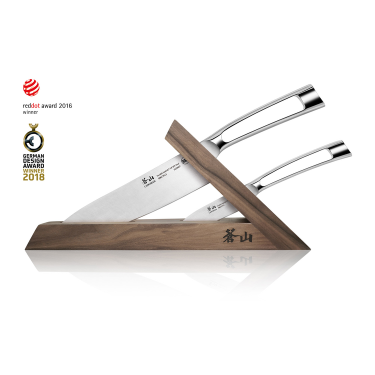 Three stainless steel knives with polished handles displayed in a triangular walnut block with engraved characters.