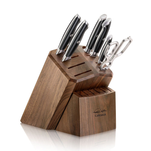 Wooden knife block holding six knives and a pair of kitchen shears, with eight empty slots for additional knives.