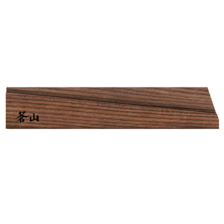 
                    
                      Solid ash wood magnetic knife sheath with a dark wood grain and black Japanese characters on one end.
                    
                  