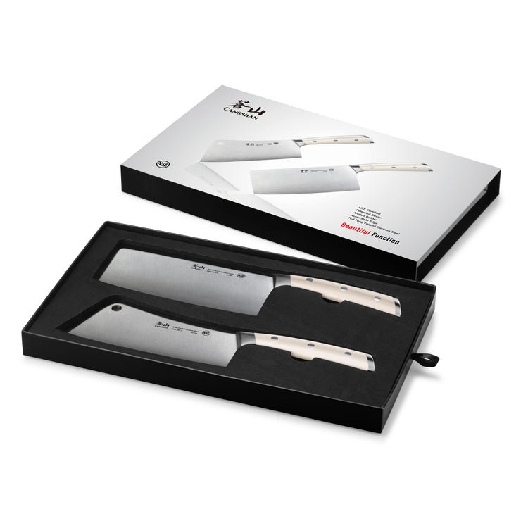 Two cleaver knives with light-colored handles in a black foam tray inside a white box with knife images and branding on the l