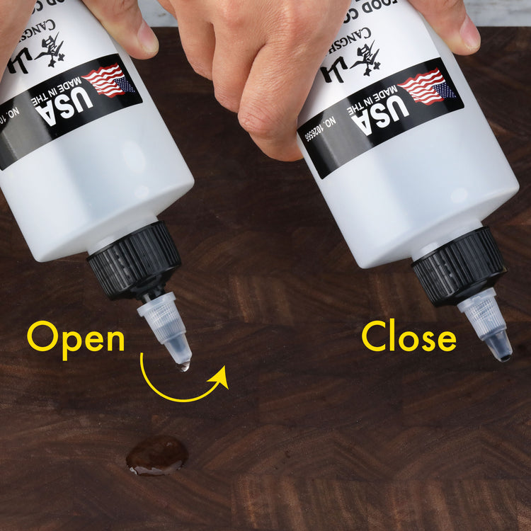 Hands demonstrating how to open and close a white mineral oil bottle with a twist cap dispensing oil on a wooden surface.