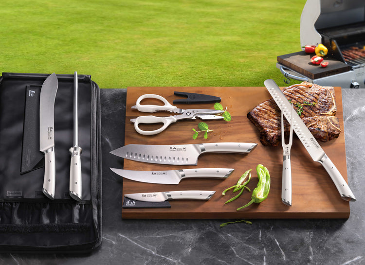Nine-piece BBQ knife set with various knives, scissors, tongs, and a sharpening rod on a wooden board and black bag.
