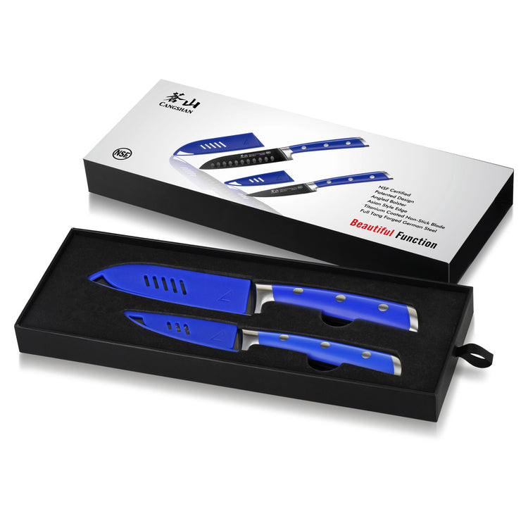 Two blue-handled knives with matching blue blade covers in a black box with a white product packaging sleeve.