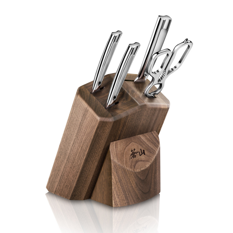 Walnut knife block holding three stainless steel knives and kitchen shears with a wooden sharpening steel holder.