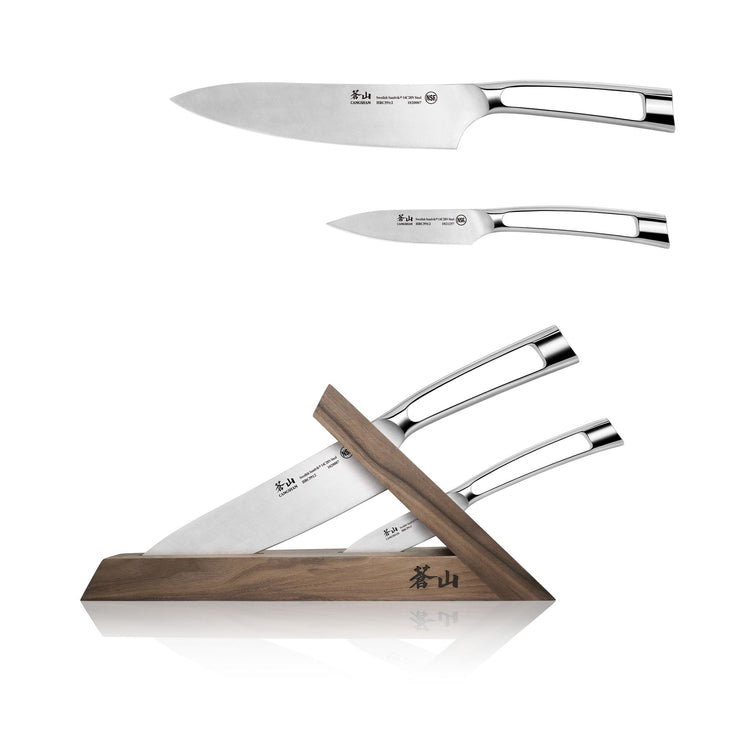 Three stainless steel knives with polished handles, two shown separately and two stored in a walnut wooden block.